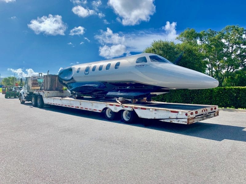 all american crating | a truck with the head of the plane being transported